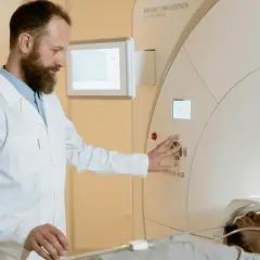 Technik elektroradiolog zarobki: specjalista obsługuje aparat MRI, dbając o pacjenta i badanie.