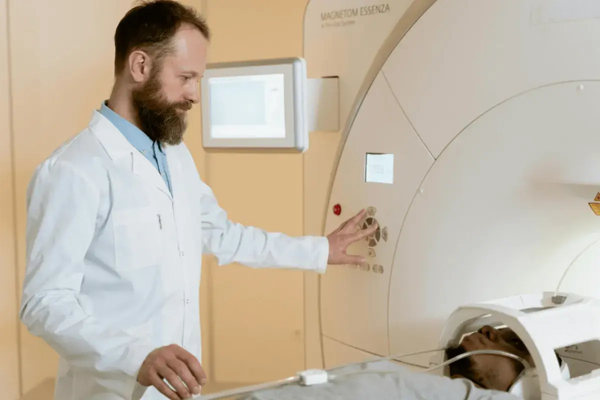 Technik elektroradiolog zarobki: specjalista obsługuje aparat MRI, dbając o pacjenta i badanie.